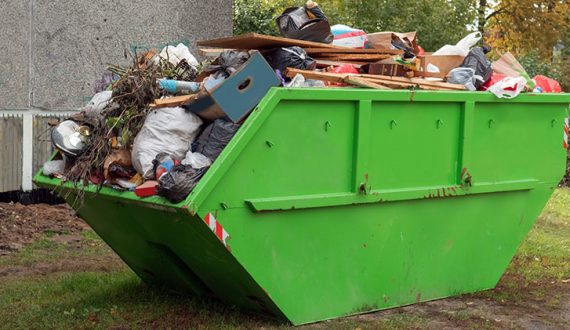 Full skip bin, after renovation. Full of rubbish and waste for unnecessary cluttering