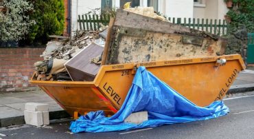 Yellow skip binned, place outside front yard full of waste from home renovation