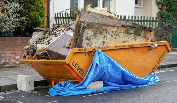 Yellow skip binned, place outside front yard full of waste from home renovation
