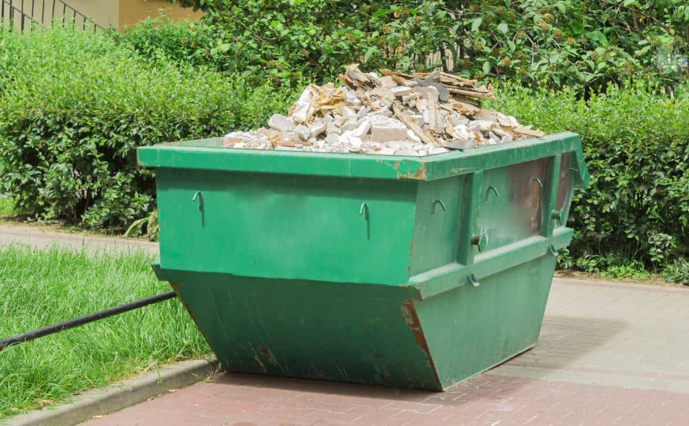 skip filled with solid household waste