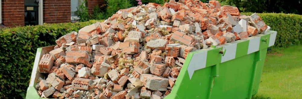 Safely stacked oversized skip bins for larger goods. Full of bricks and construction waste.