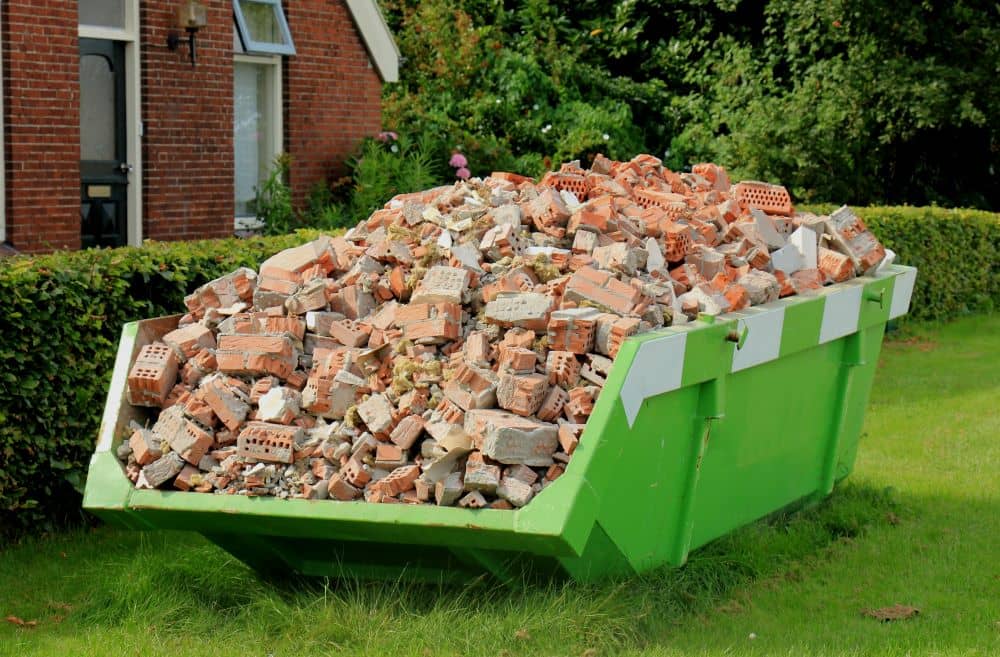 Safely stacked oversized skip bins for larger goods. Full of bricks and construction waste.