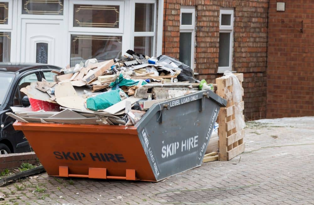 Hired skip bin filled with rubbish.