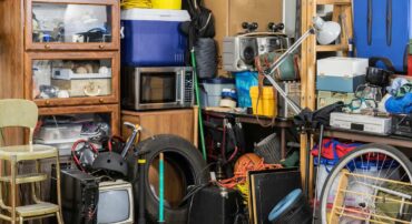 A garage room full of clutter demonstrating how to start decluttering when overwhelmed