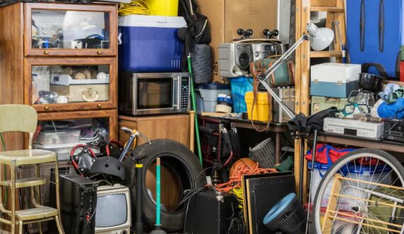 A garage room full of clutter demonstrating how to start decluttering when overwhelmed