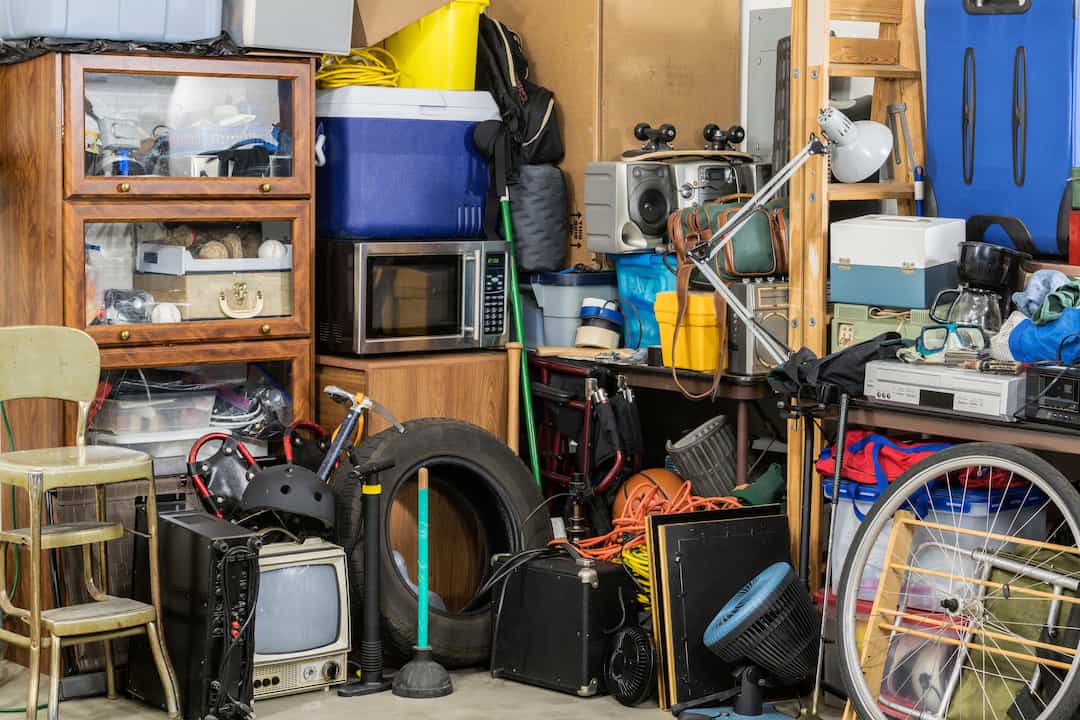 A garage room full of clutter demonstrating how to start decluttering when overwhelmed